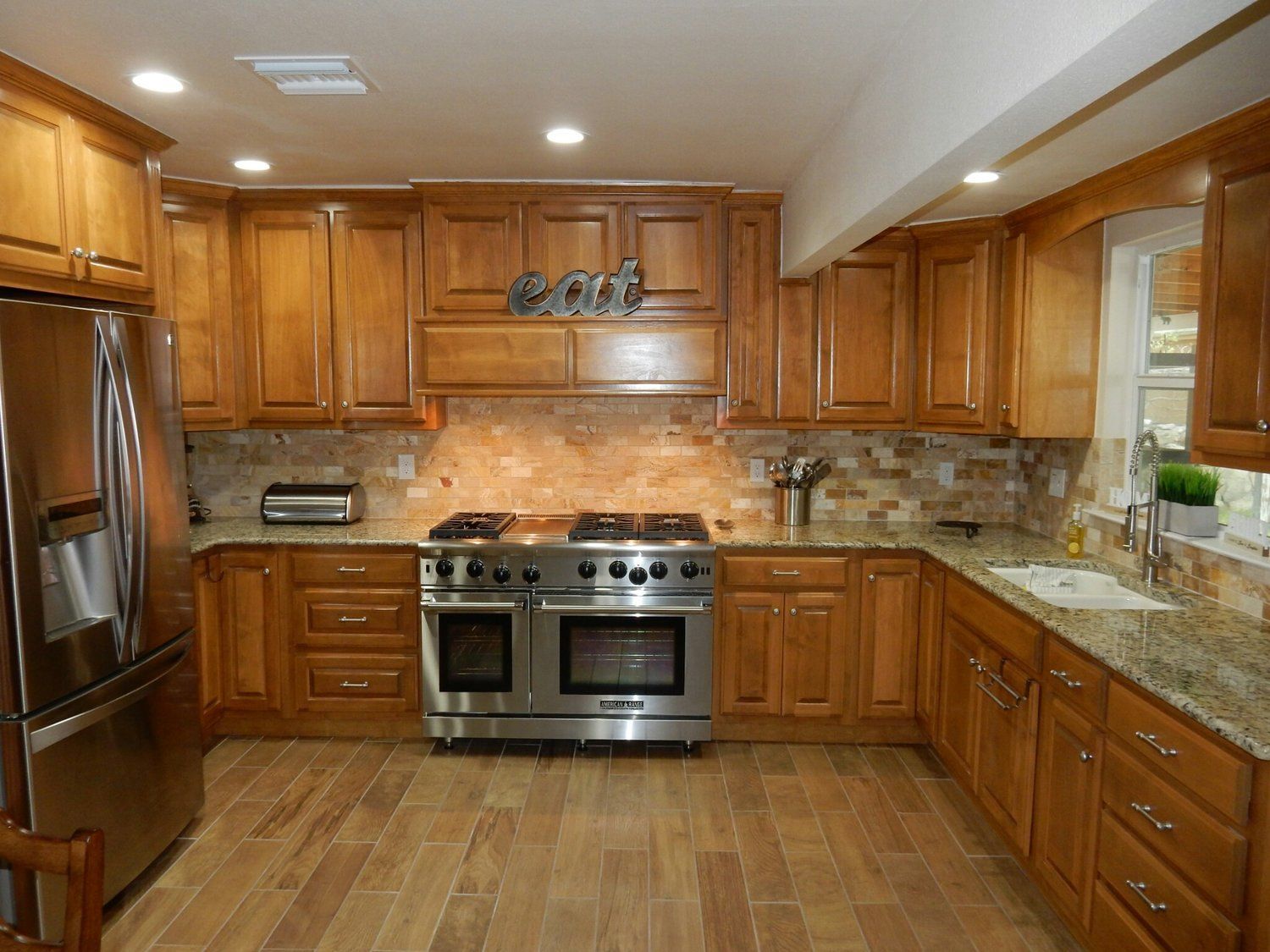 A kitchen with stainless steel appliances and wooden cabinets