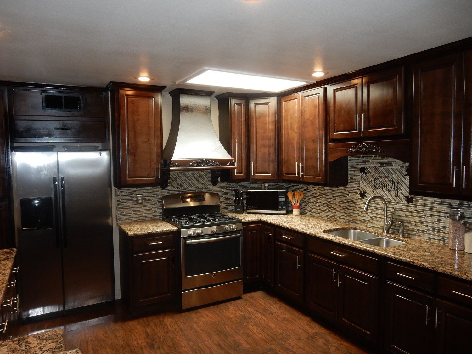 A kitchen with stainless steel appliances and wooden cabinets