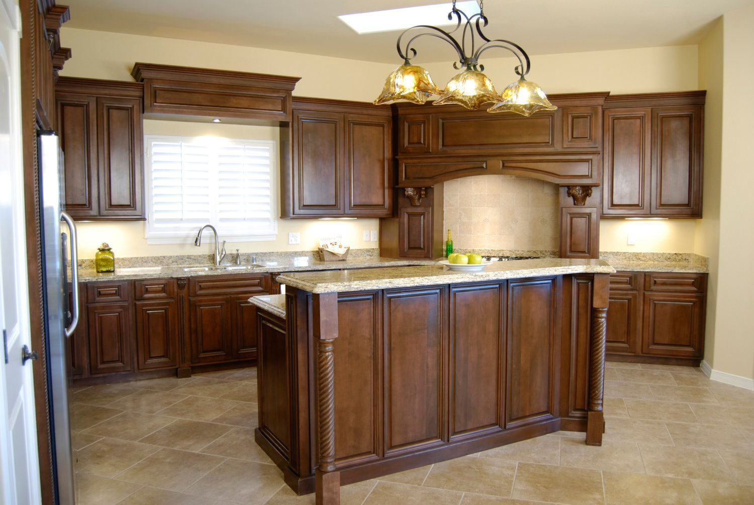 A kitchen with wooden cabinets and granite counter tops