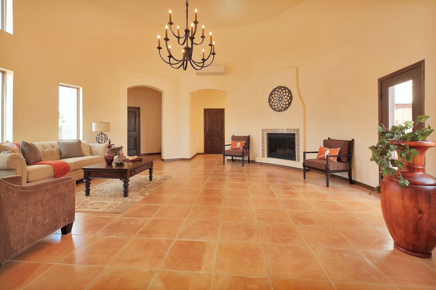 A living room with a couch , chairs , coffee table and fireplace.