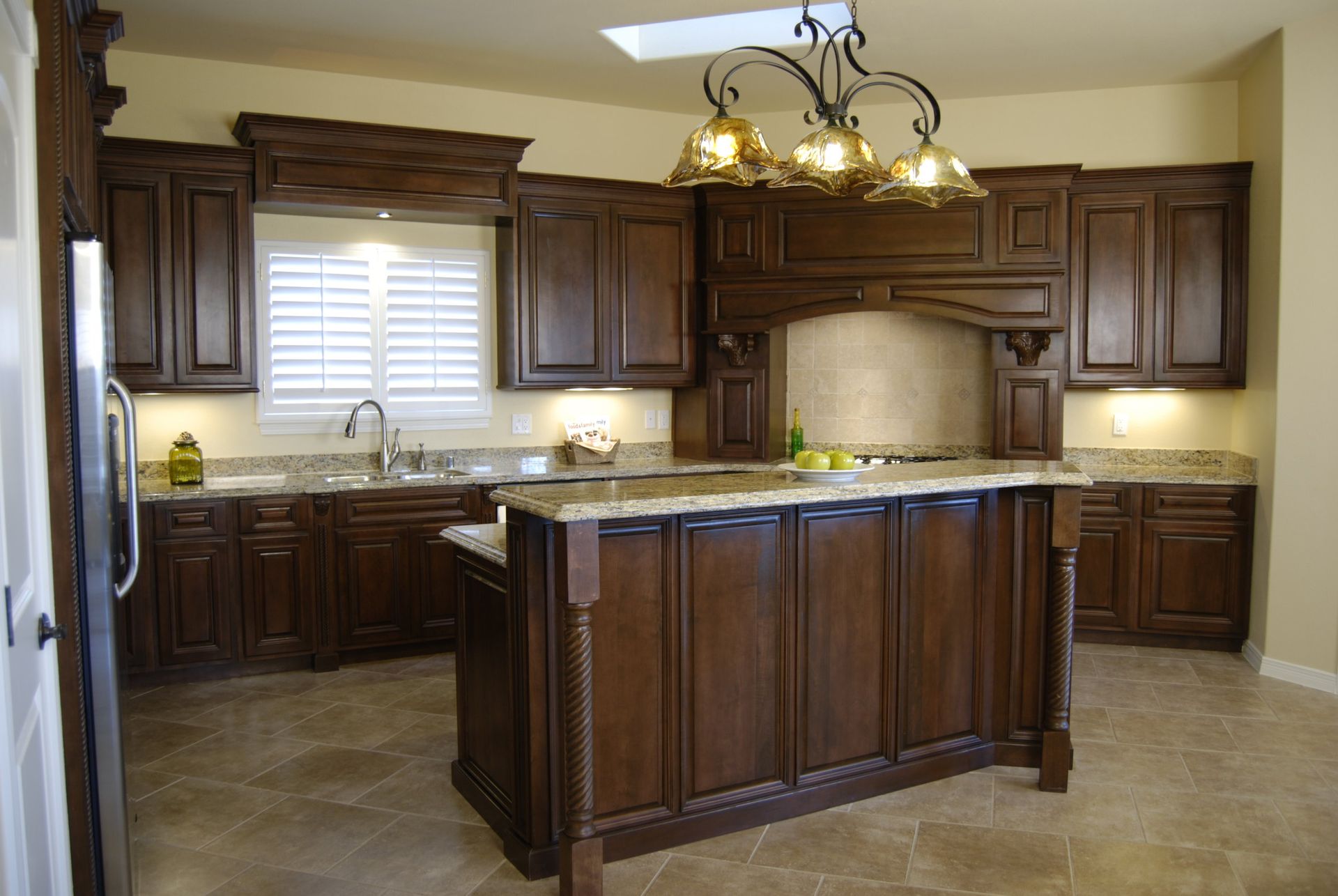 A kitchen with wooden cabinets and granite counter tops