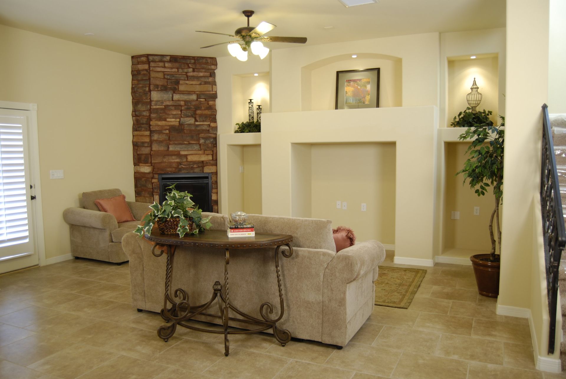 A living room with a fireplace and a ceiling fan