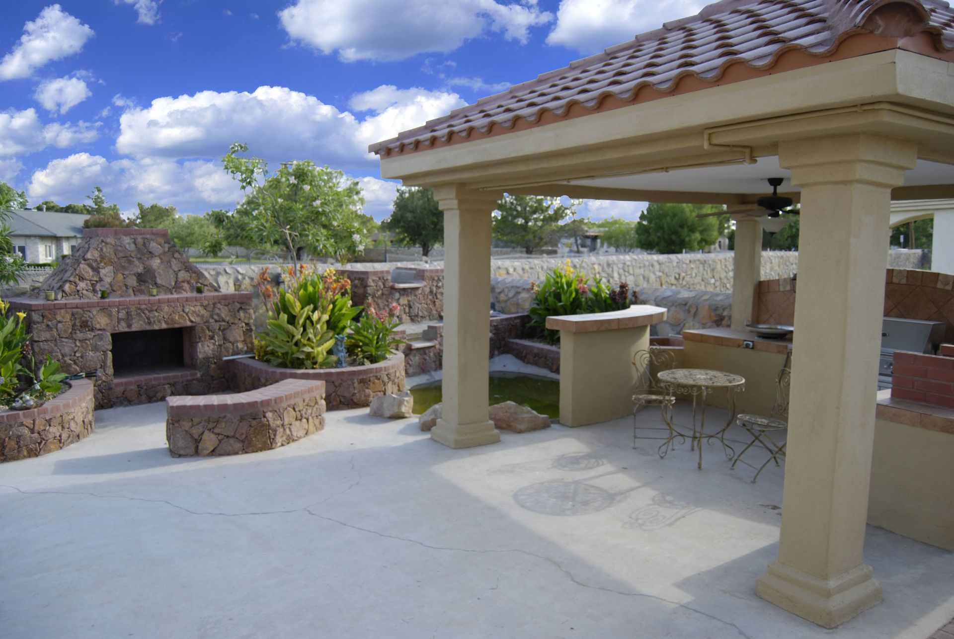 A patio with a ceiling fan and a fireplace