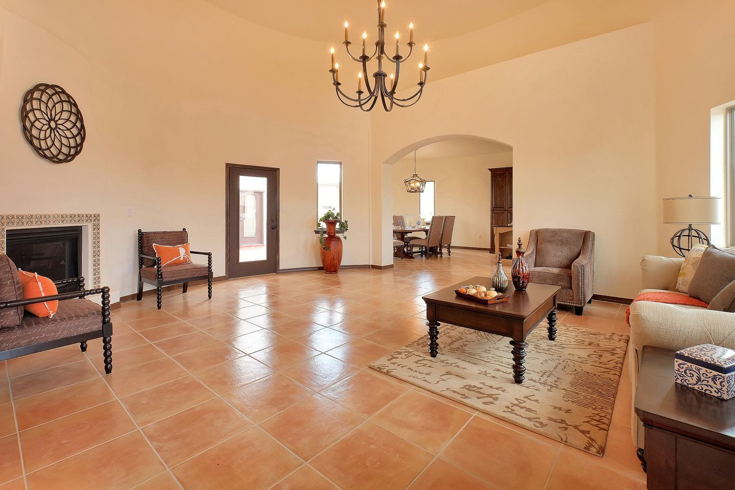 A living room with a couch , chairs , coffee table and fireplace.