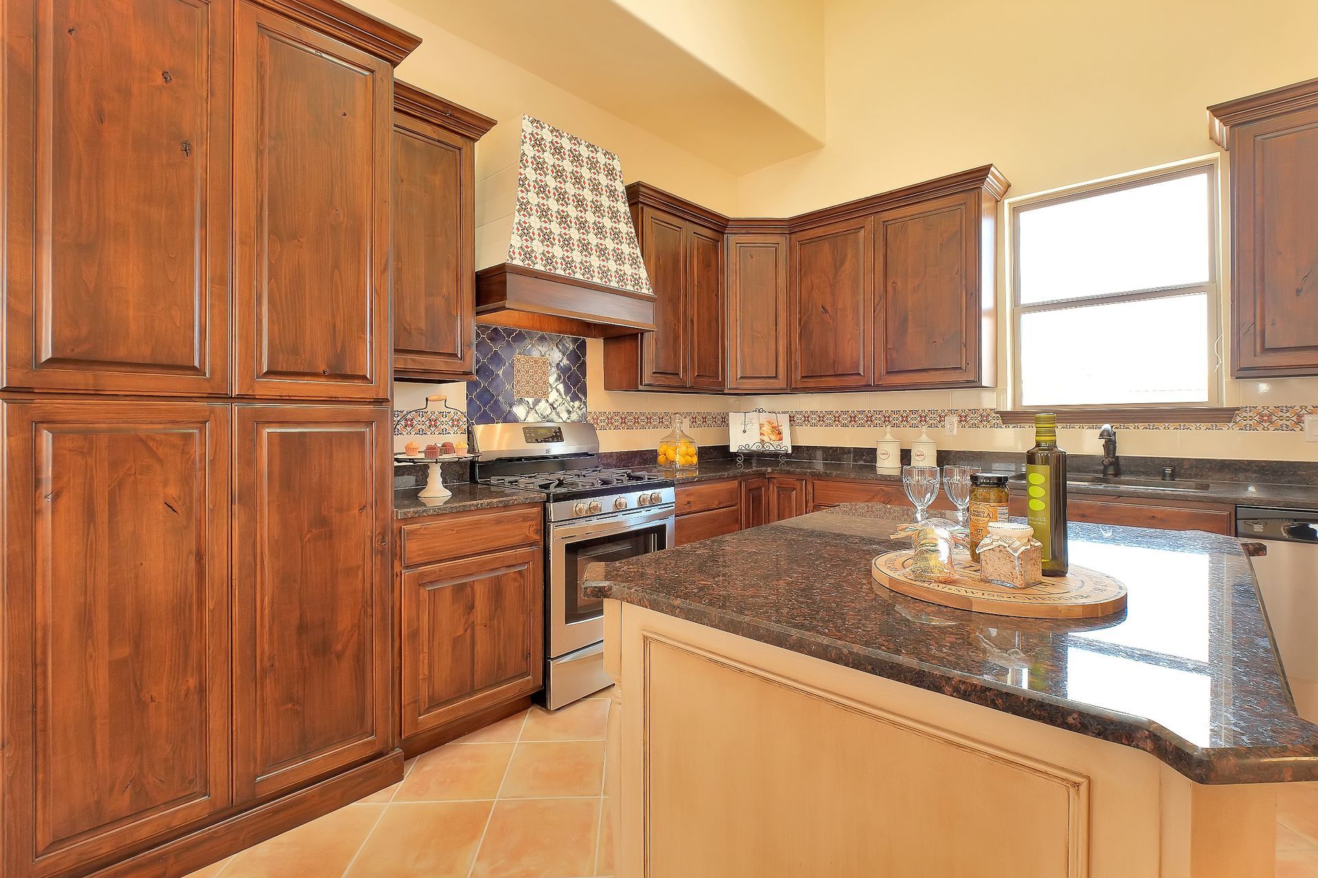 A kitchen with wooden cabinets and granite counter tops