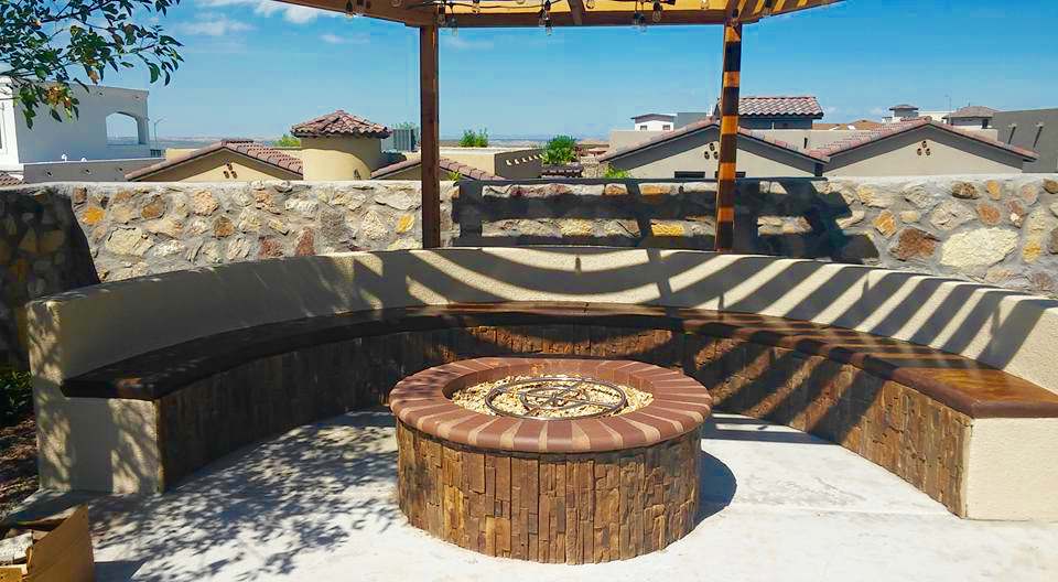 There is a fire pit in the middle of the patio.