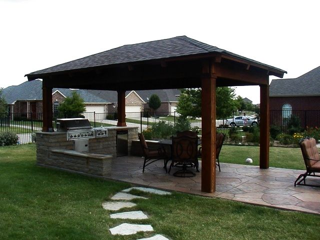 A gazebo with a table and chairs underneath it