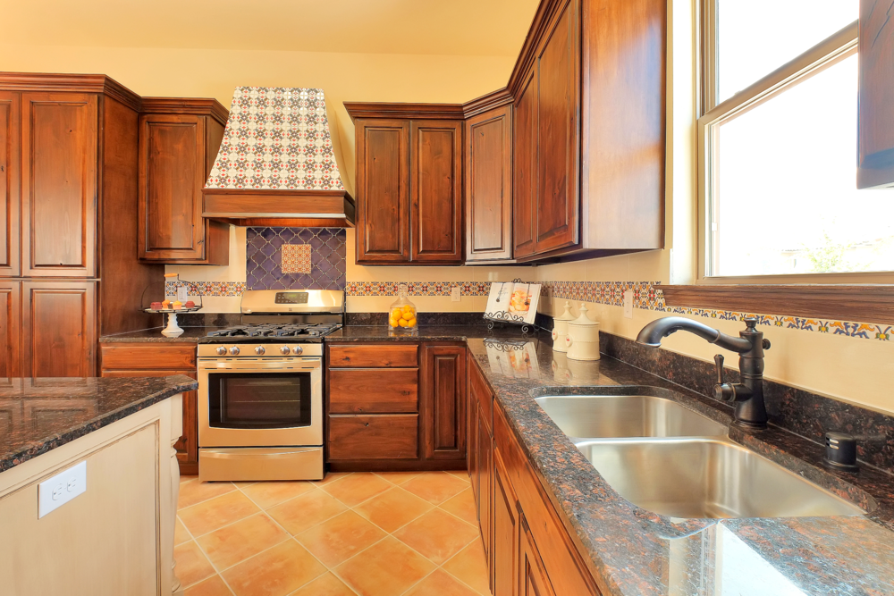A kitchen with stainless steel appliances and wooden cabinets