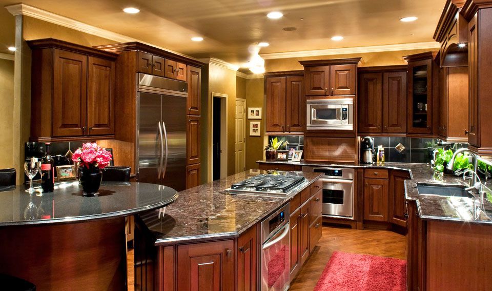 A kitchen with stainless steel appliances and wooden cabinets