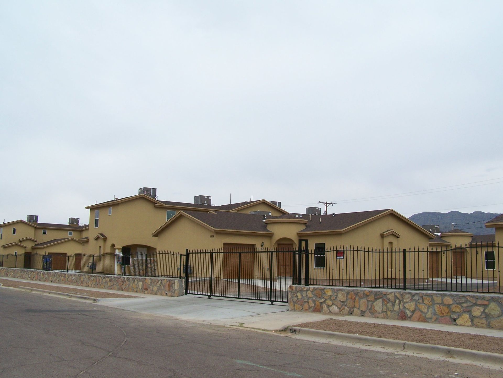 A row of houses with a fence around them