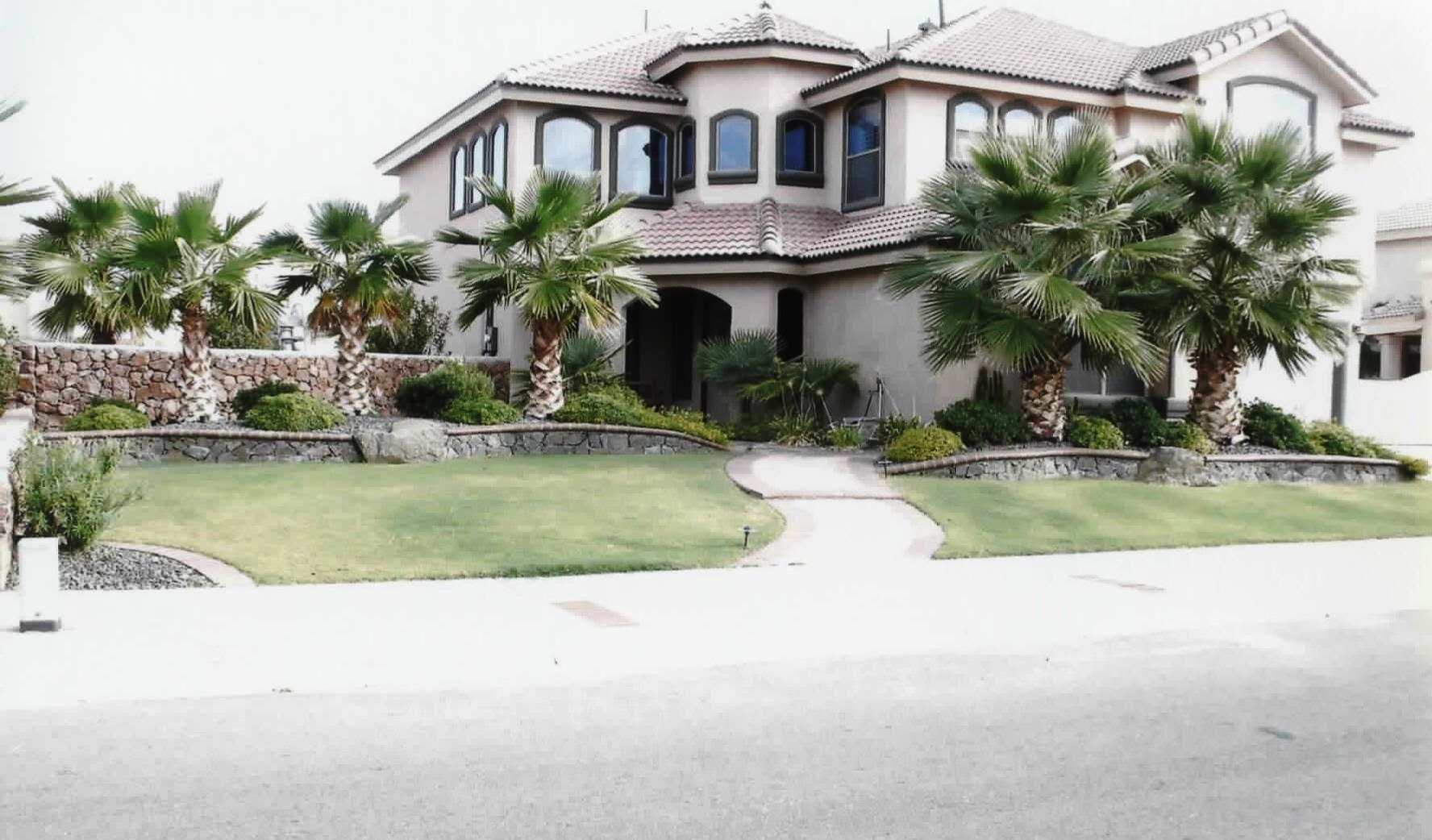 A large house with palm trees in front of it