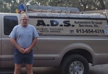 A man standing in front of an a.d.s. truck