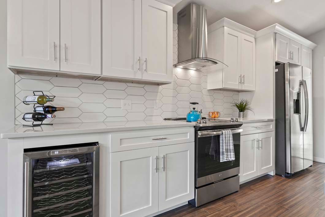 A kitchen with white cabinets and stainless steel appliances.