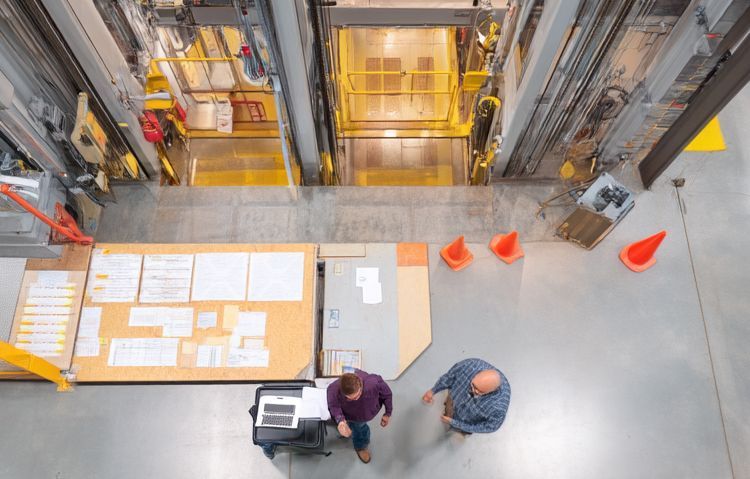 consultant and inspector reviewing elevator test results
