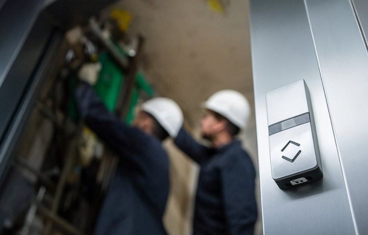elevator technicians performing maintenance and inspections