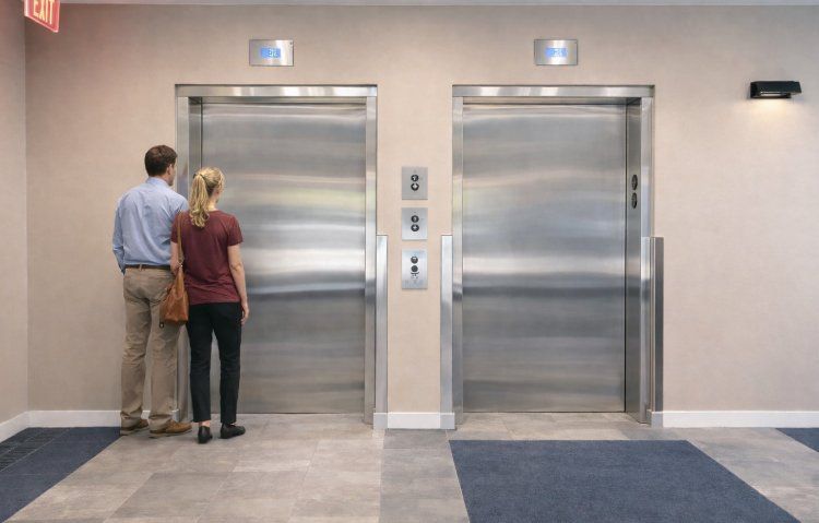 hospital elevator with passengers waiting in a quiet hall