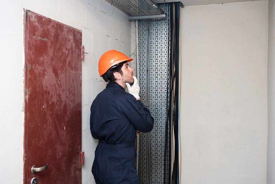 male-inspecting-elevator
