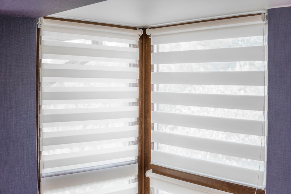 A Pair of White Blinds on a Window in a Room — Tully Blinds in Tully, QLD