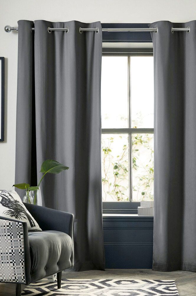 A Living Room With a Couch and a Window With Gray Curtains — Tully Blinds in Innisfail, QLD
