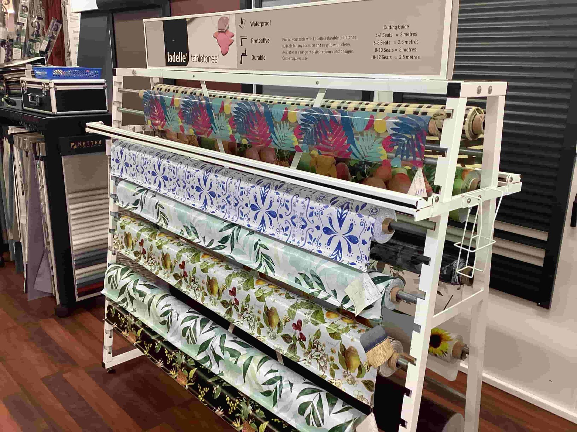 A Rack Filled With Rolls of Wrapping Paper in a Store — Tully Blinds in Tully, QLD