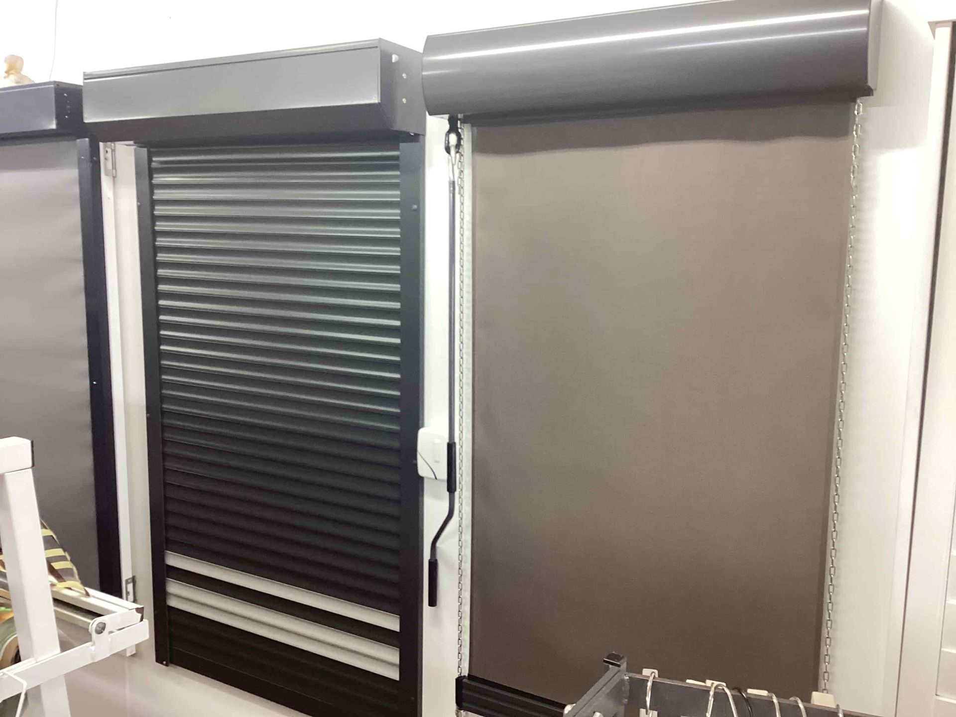 A Row of Roller Shutters Are Sitting Next to Each Other in a Room — Tully Blinds in Tully, QLD