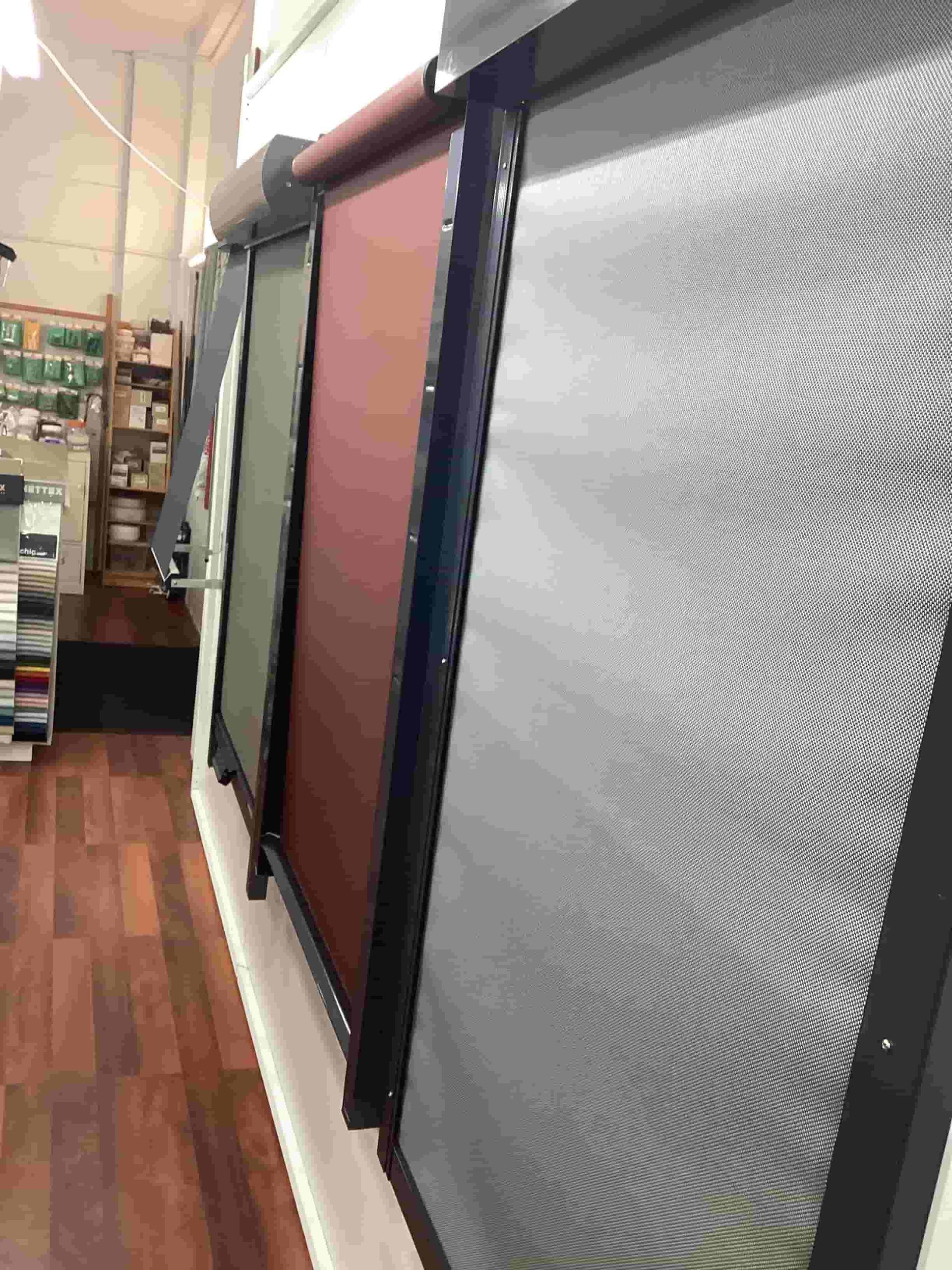 A Row of Screens Hanging on a Wall in a Store — Tully Blinds in Tully, QLD