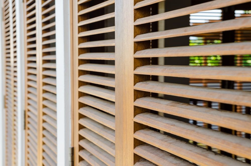 A Close Up of Wooden Shutters on a Window — Tully Blinds in Cardwell, QLD