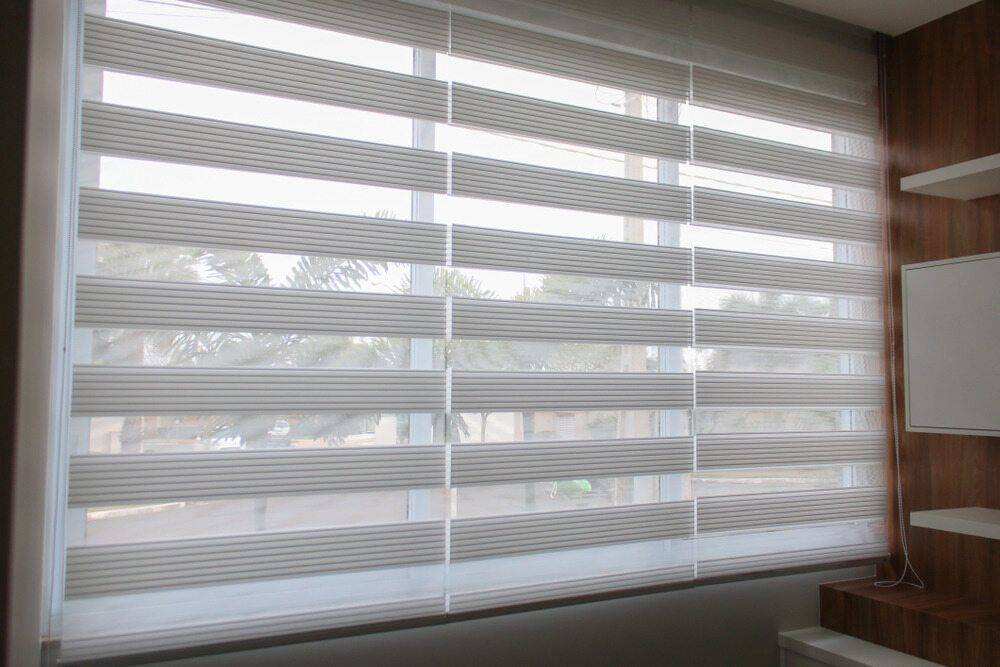 A Window With a Striped Blind on It in a Room — Tully Blinds in Tully, QLD
