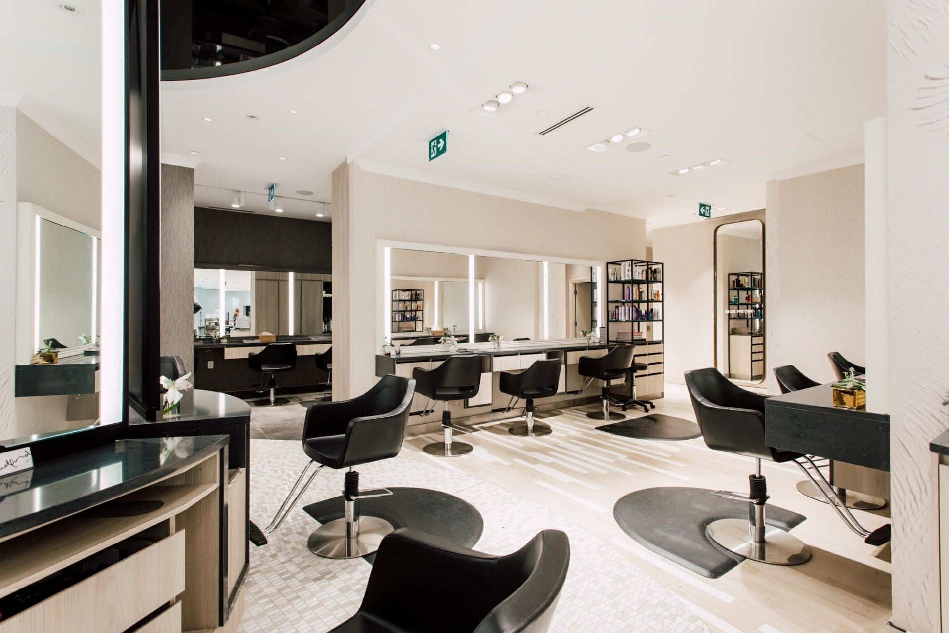 A hair salon with a lot of chairs and mirrors.