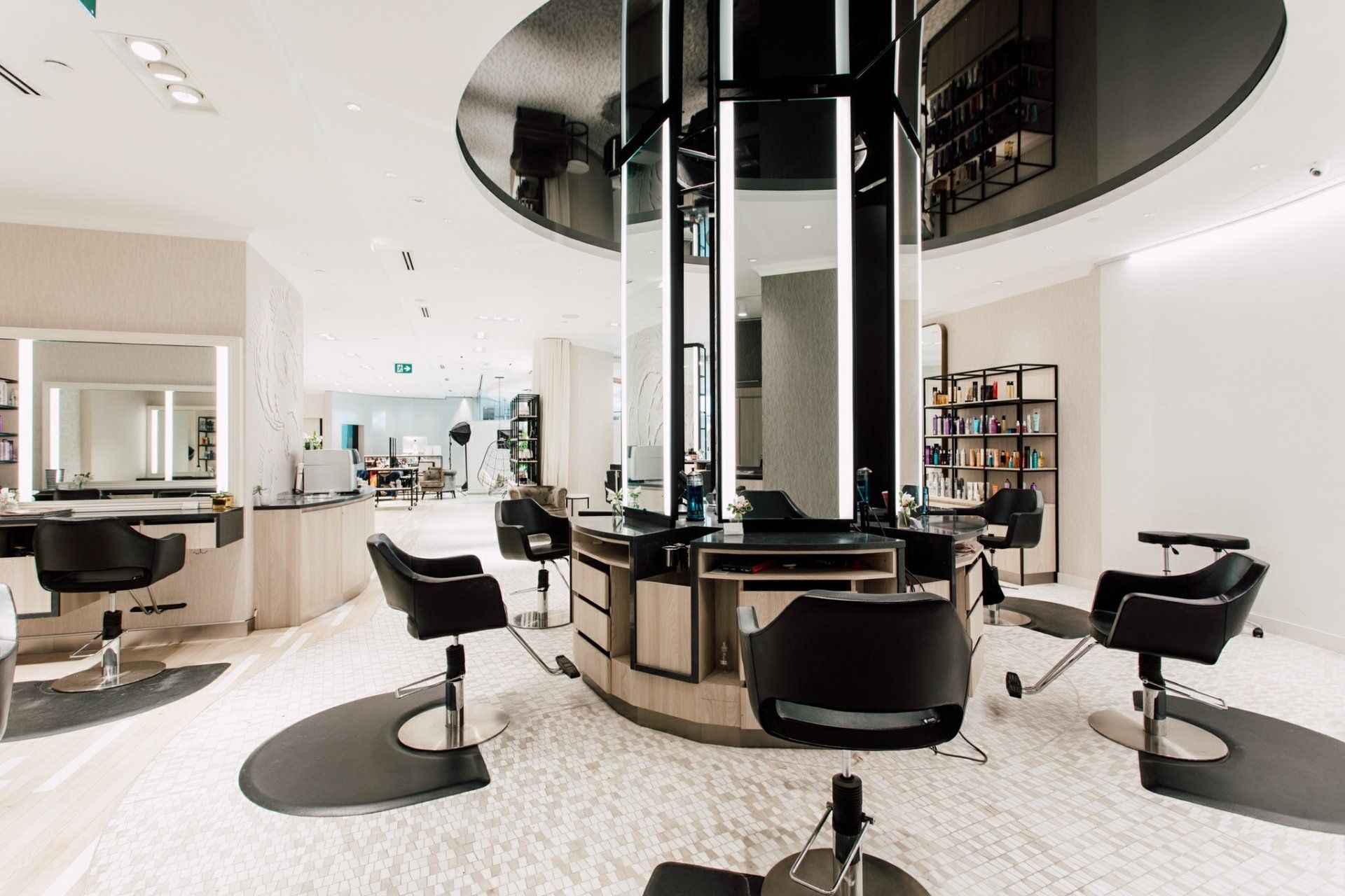 A hair salon with a lot of chairs and mirrors.