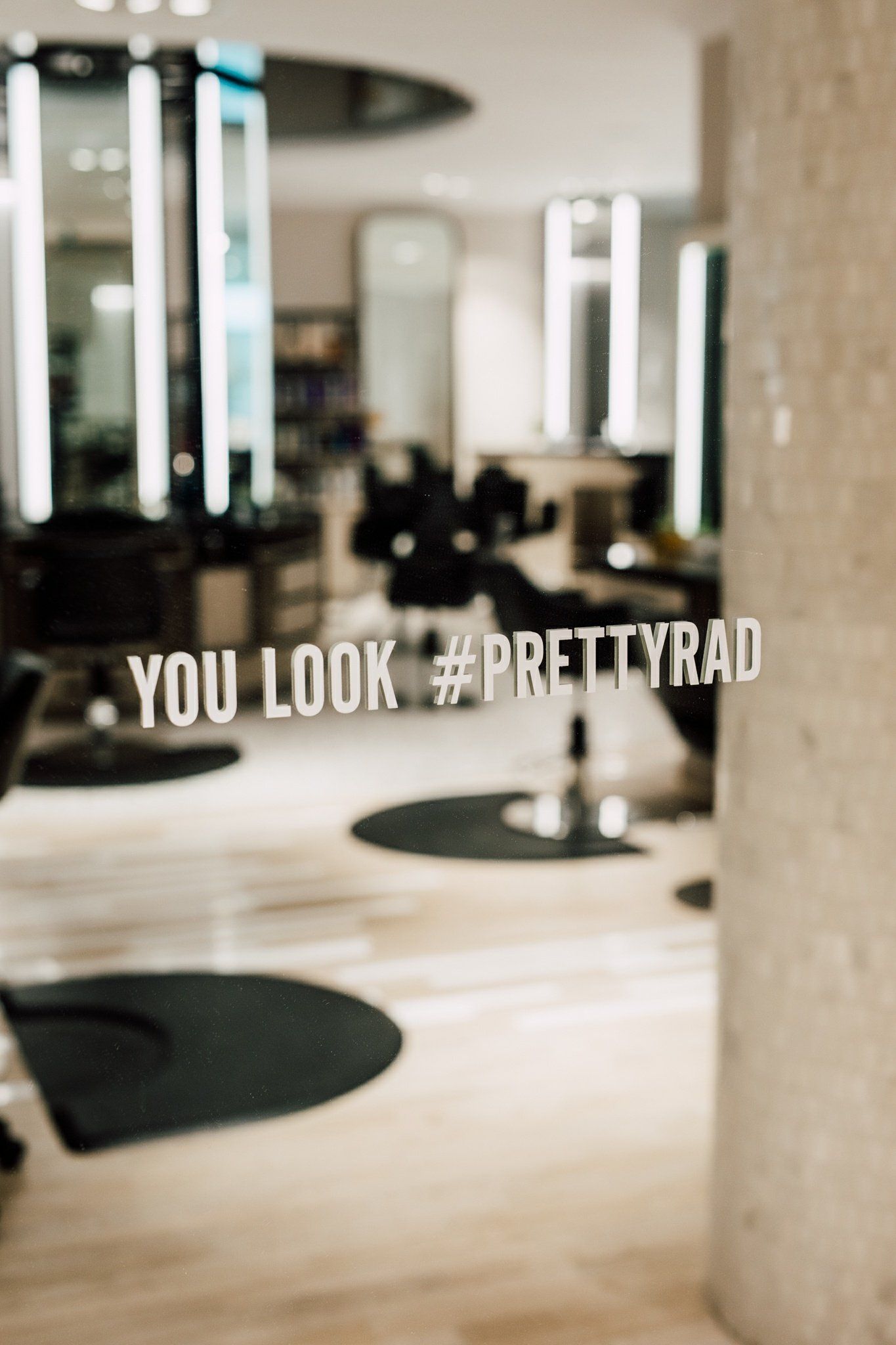 A mirror in a hair salon says `` you look pretty rad ''.
