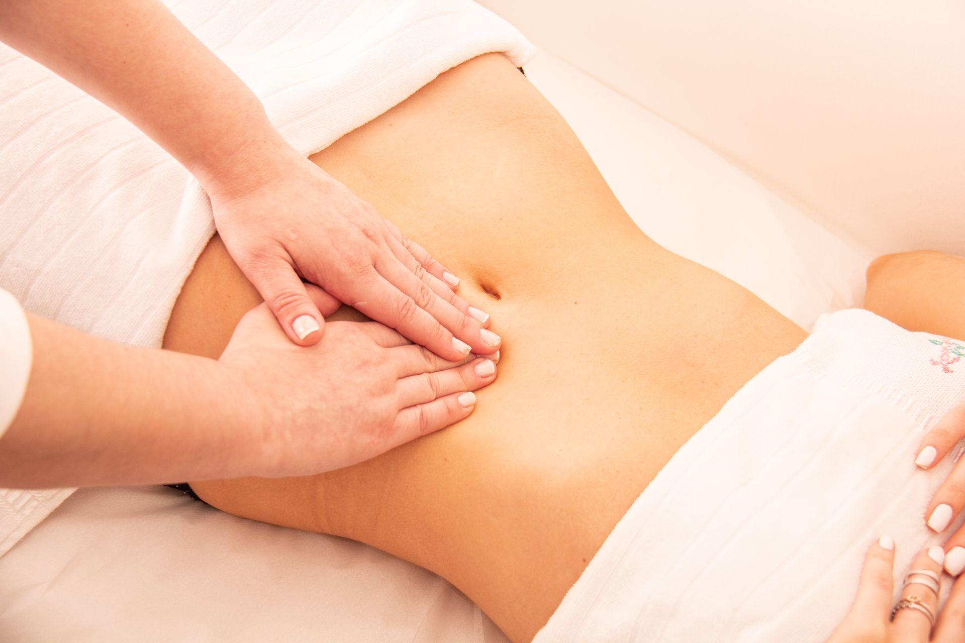 A woman is getting a massage on her stomach in a spa.