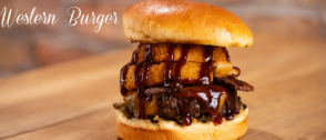 Western Burger with onion rings, and barbecue sauce.