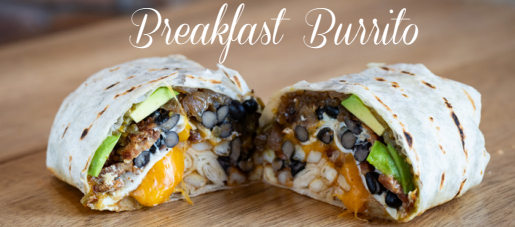 Breakfast burrito cut in half, revealing fillings including beans, cheese, and avocado.