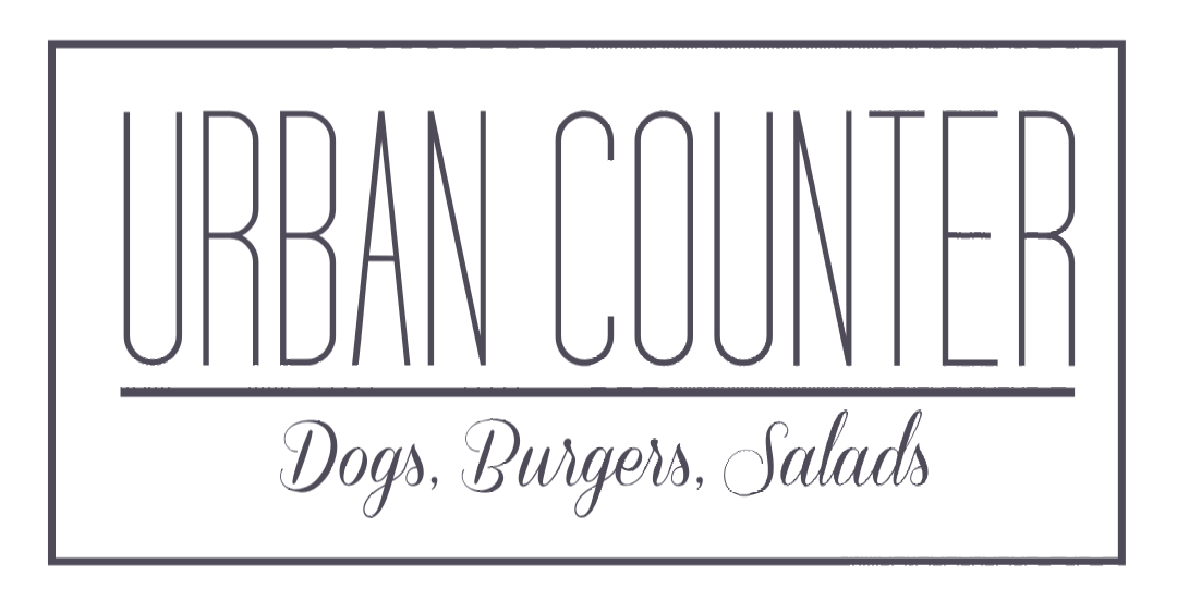 Logo for Urban Counter: text within a rectangle, reads "Urban Counter" above "Dogs. Burgers. Salads" in script.