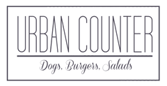 Logo for Urban Counter: text within a rectangle, reads "Urban Counter" above "Dogs. Burgers. Salads" in script.