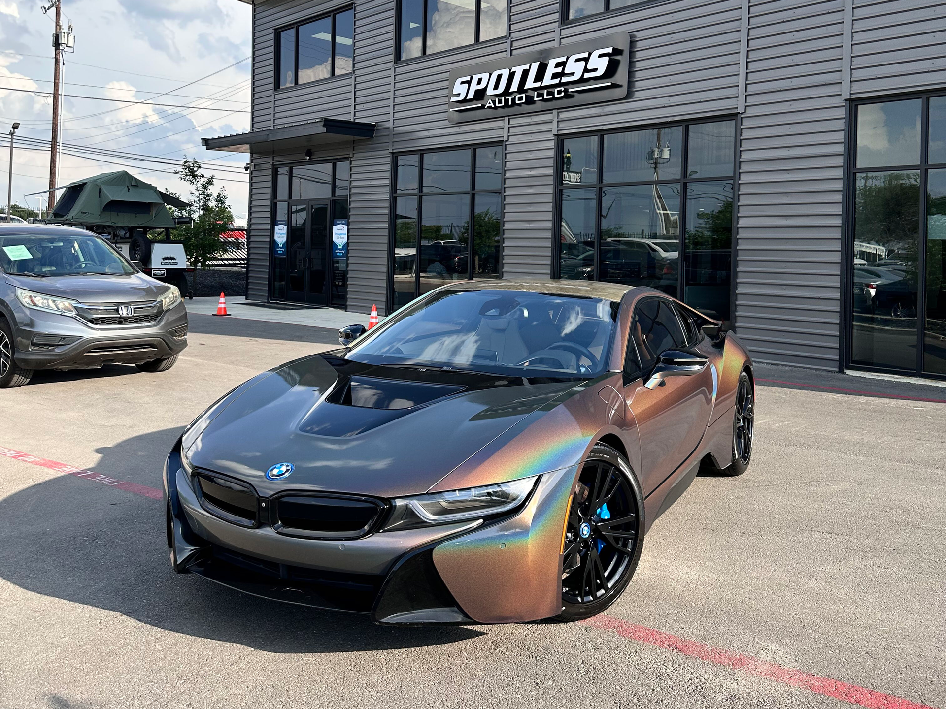 A metallic color BMW i8 sports car parked in front of