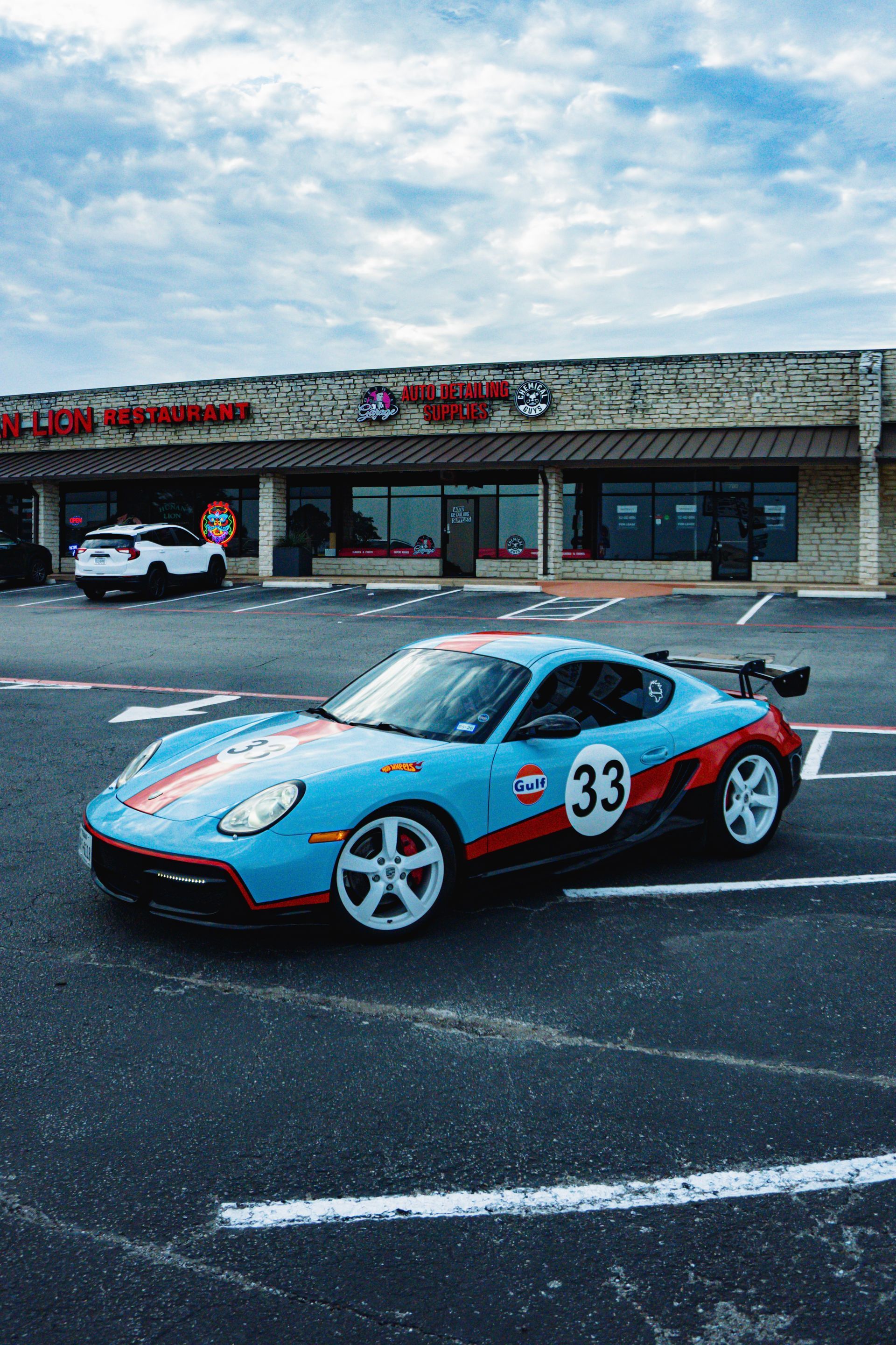 Close-up of a red BMW sports car front, showcasing headlights and a black grille.