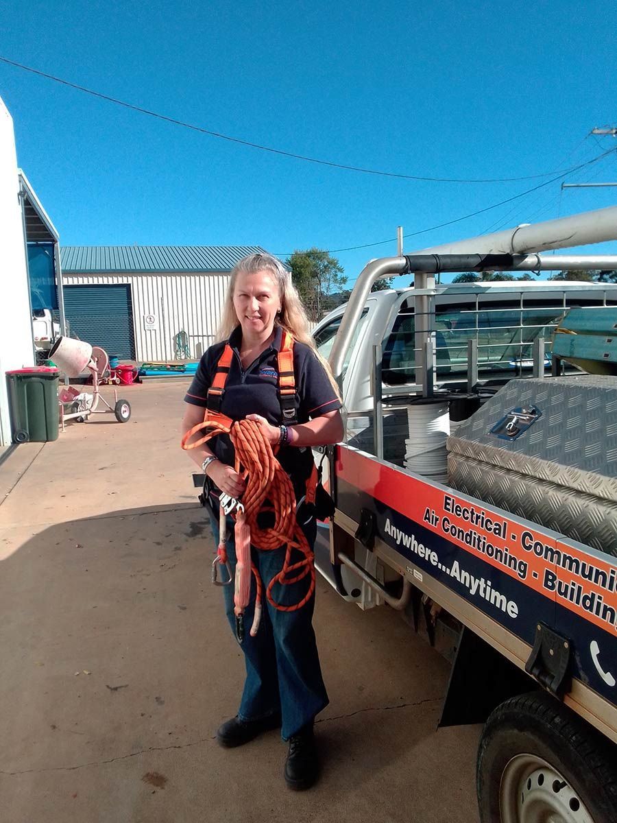 A Woman is Standing in Front of a Truck Holding a Rope — Wards Group QLD in Murgon, QLD