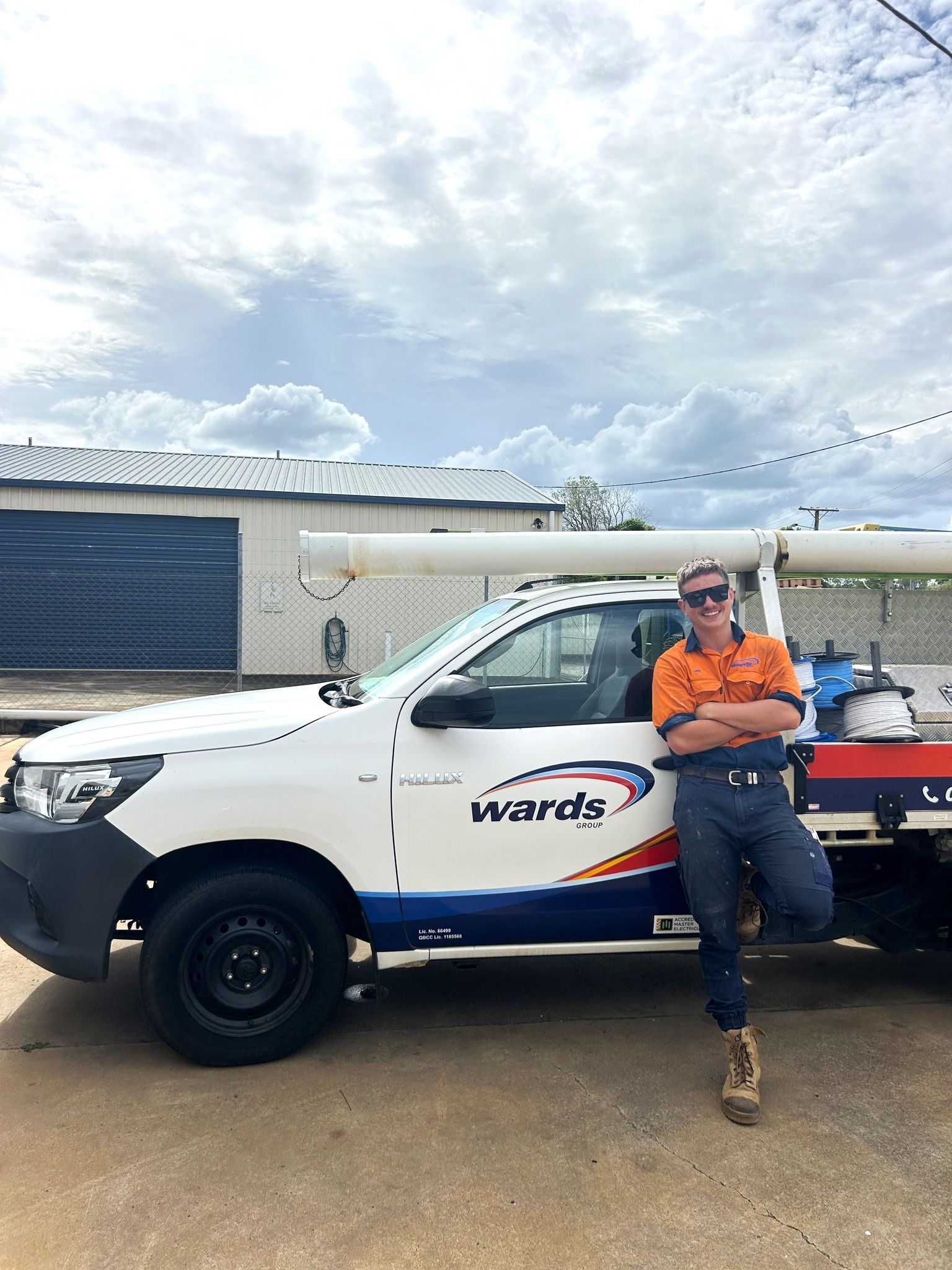 Man leaning on a white work truck with
