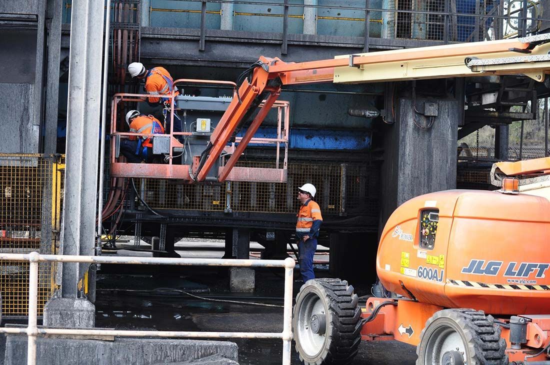 A Group of Construction Workers Are Working on a Building — Wards Group QLD in Nanango, QLD
