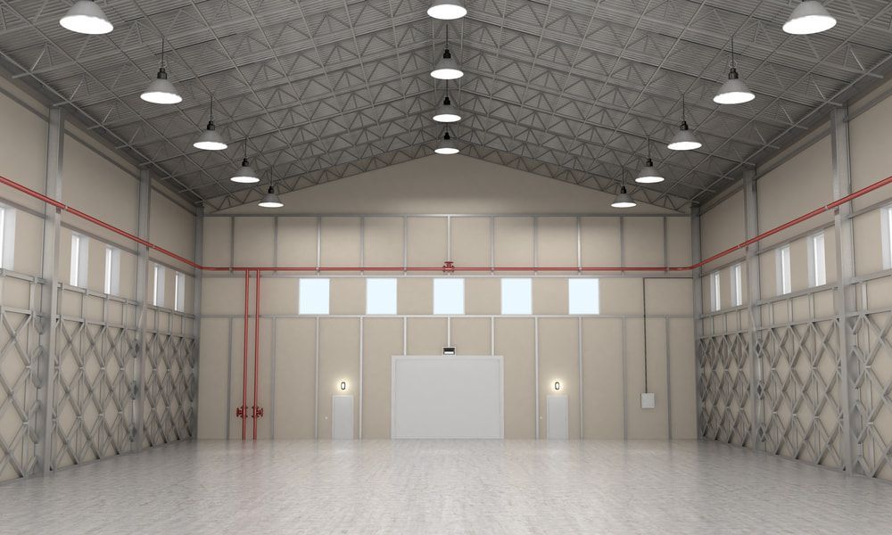 A Large Empty Warehouse With Lots of Windows and Ceiling Lights — Wards Group QLD in Wondai, QLD