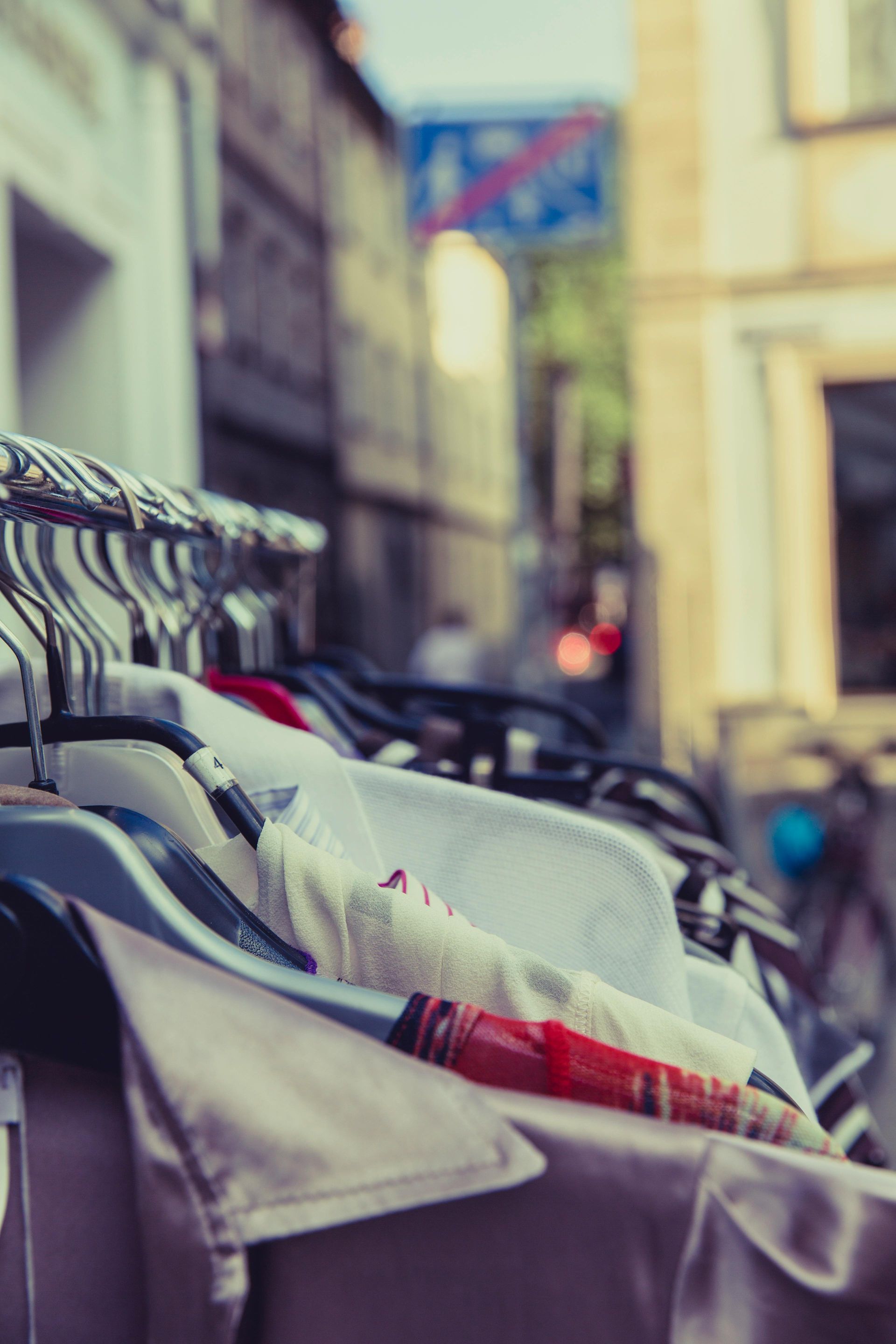 A bunch of clothes are hanging on a rack outside