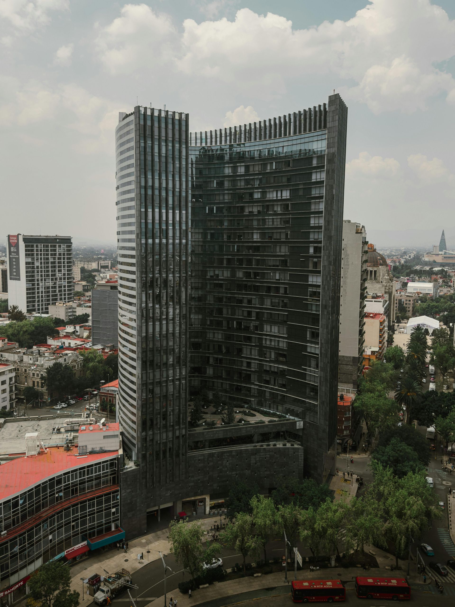 An aerial view of a large building in the middle of a city.