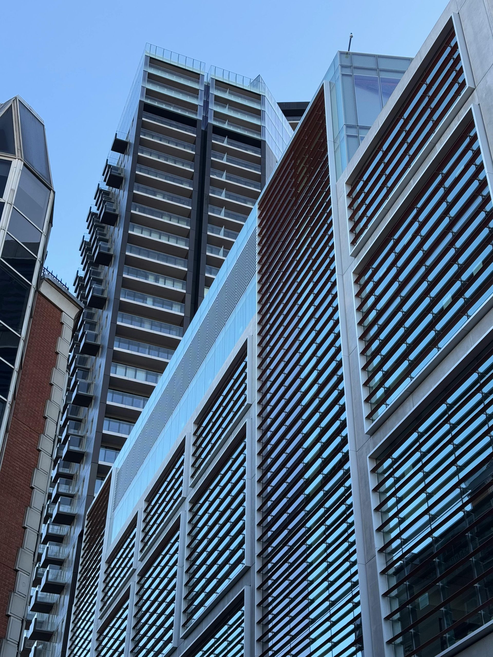 A row of tall buildings with a blue sky in the background