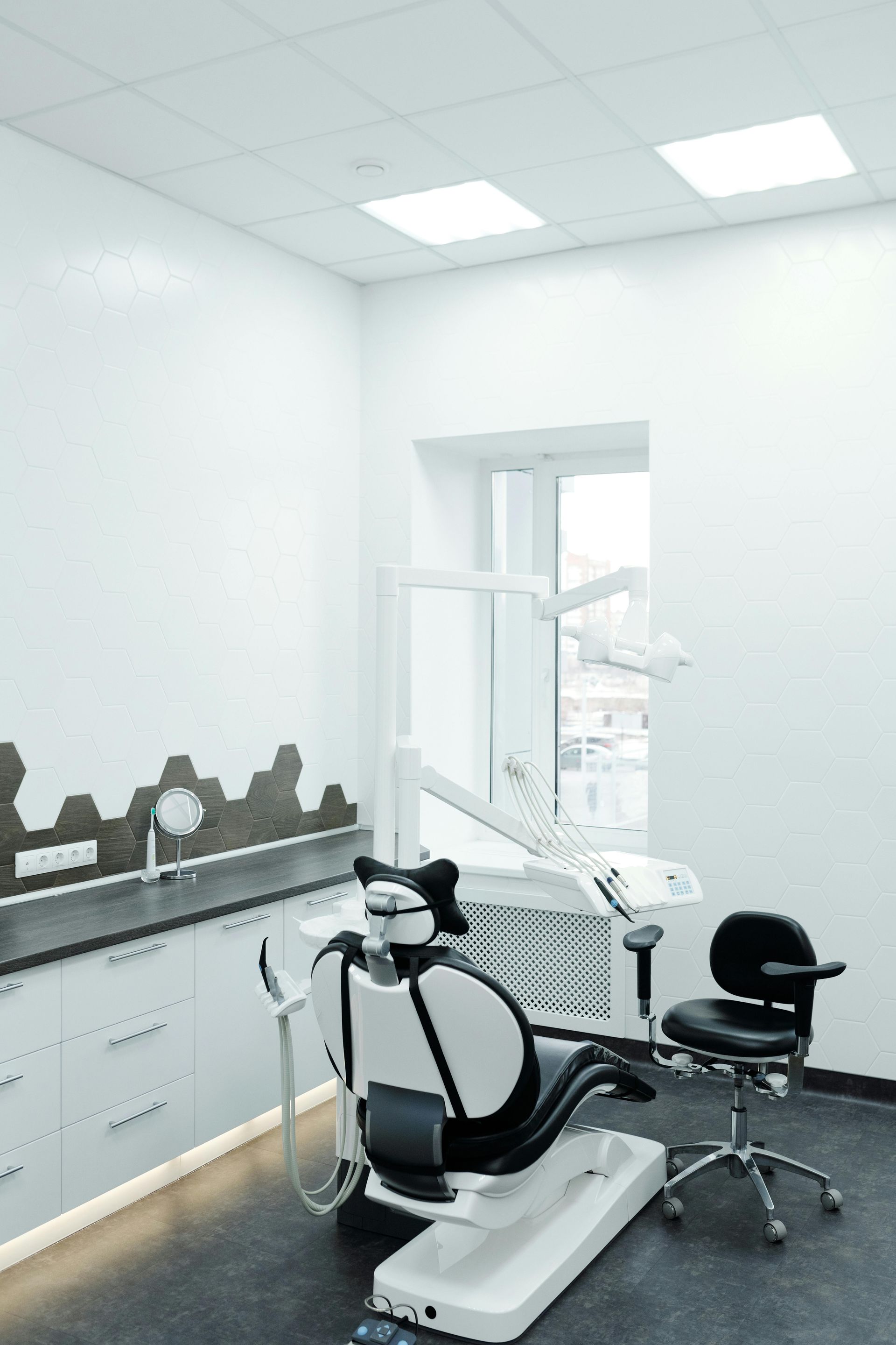 A dental office with a dental chair and a sink.