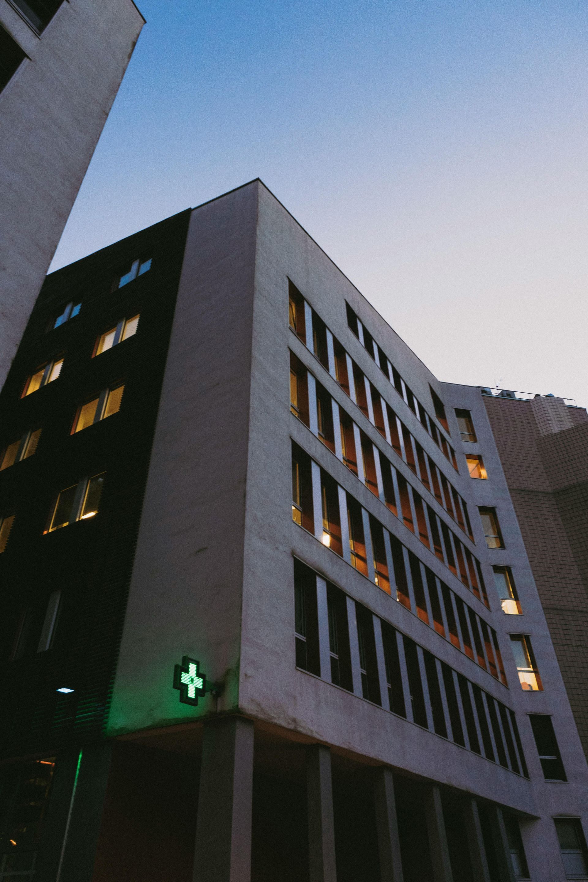 A large building with a green cross on the side of it