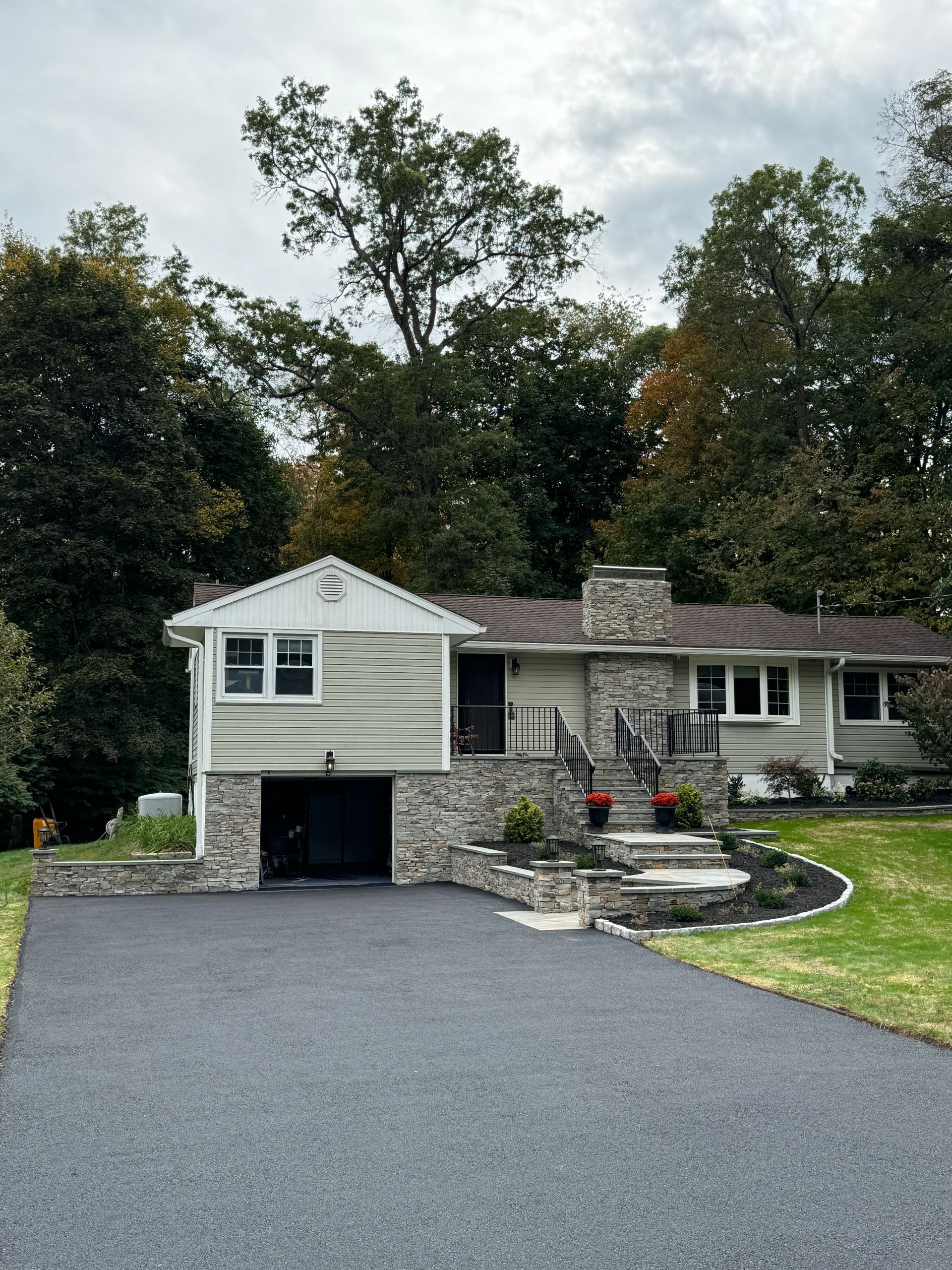 A house with a garage and a driveway in front of it