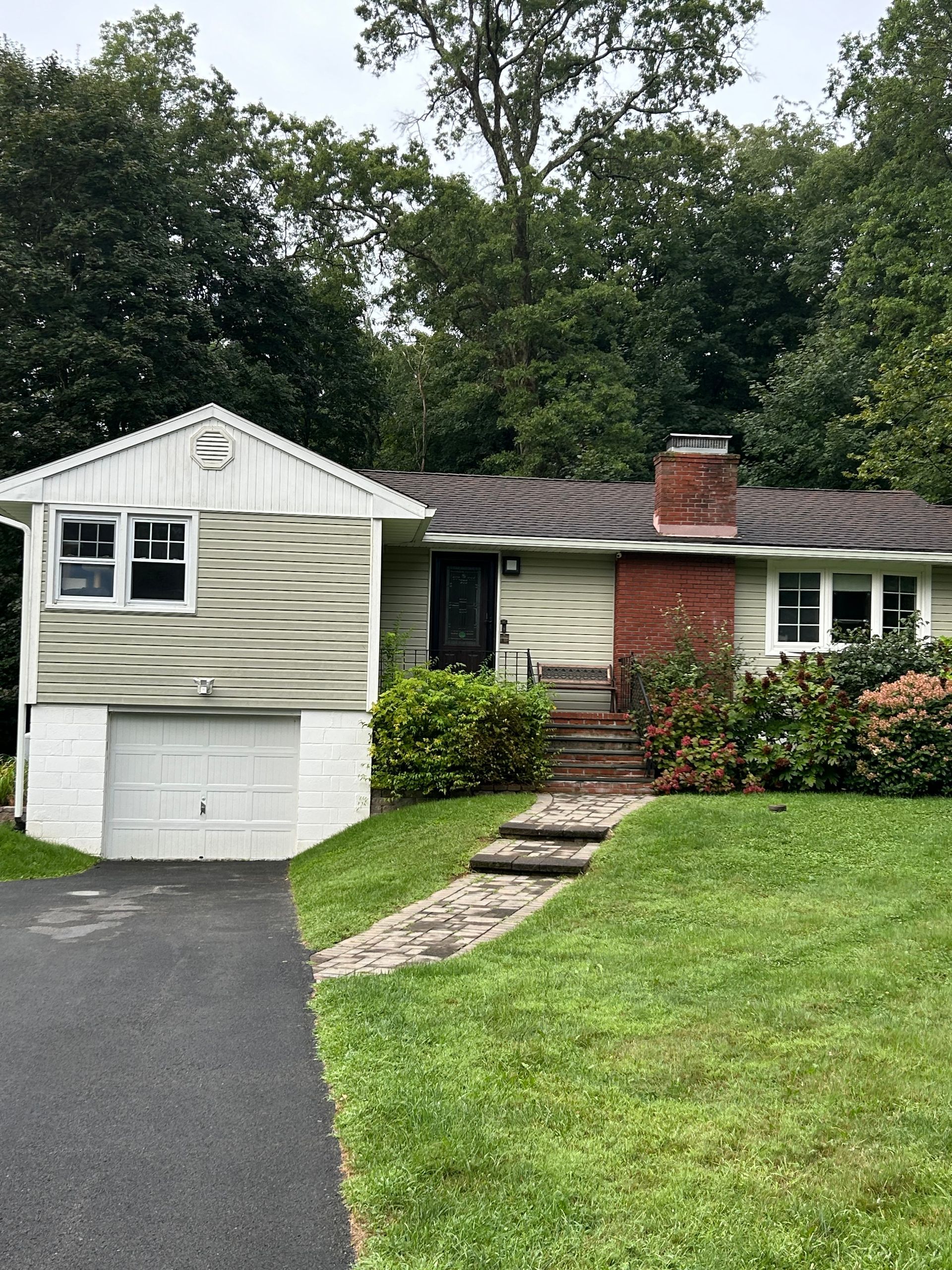 A house with a garage and a walkway leading to it