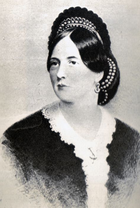 A black and white photo of a woman wearing a tiara